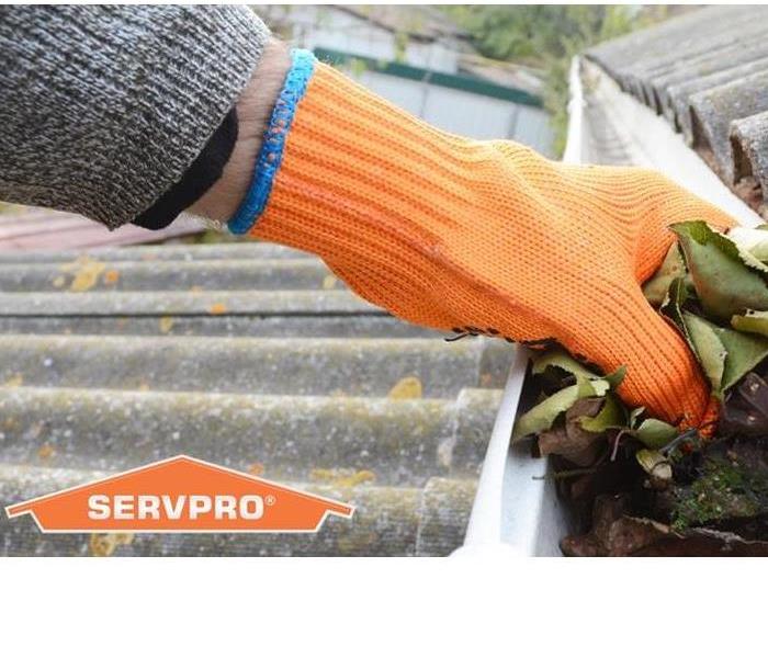 SERVPRO representative cleaning out the rain gutters