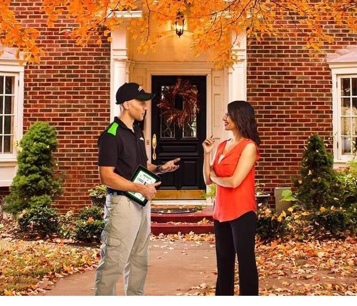 SERVPRO representative speaking to home owner about fire safety 